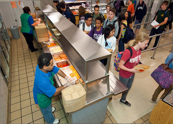 Students and workers in a school cafeteria