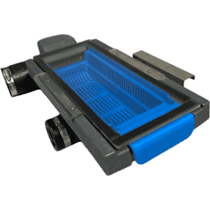 A rectangular gray plastic self-cleaning grease trap with a transparent lid and blue handle; inside is a blue perforated basket. The device features metal clamps and pipe connections on the sides, set against a plain background.