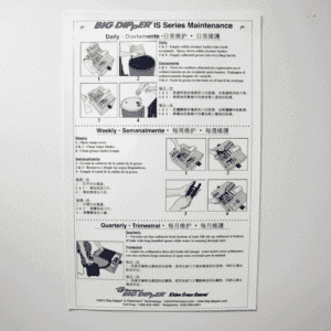 A maintenance instruction poster for the Big Dipper IS Series automatic oil and grease separator shows daily, weekly, and quarterly maintenance steps with labeled images and text in English, Spanish, and Chinese on a white wall.
